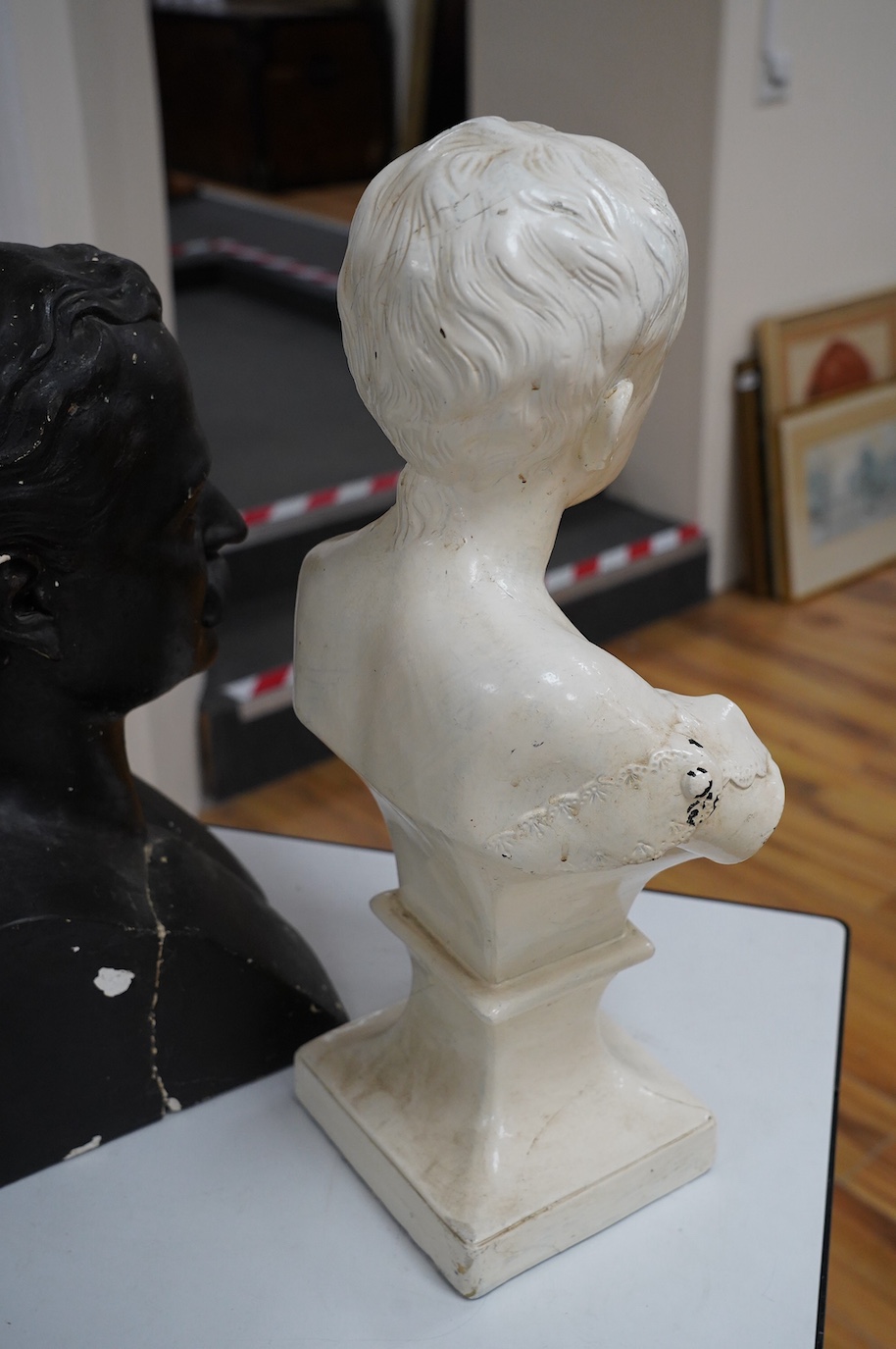 Three decorative plaster busts; the Duke of Wellington, 60cm high, another male figure, and a child. Condition - poor